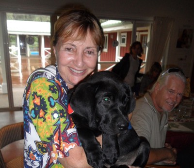 Makana Aloha founder, JoRene Valkirs with a puppy in training at Assistance Dogs of Hawaii